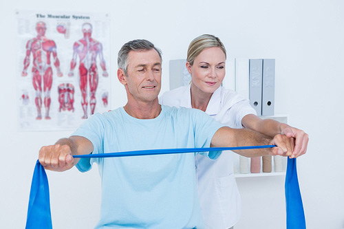 Female osteopath helping a patient stretch